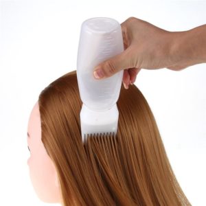 Bouteille de teinture capillaire avec applicateur